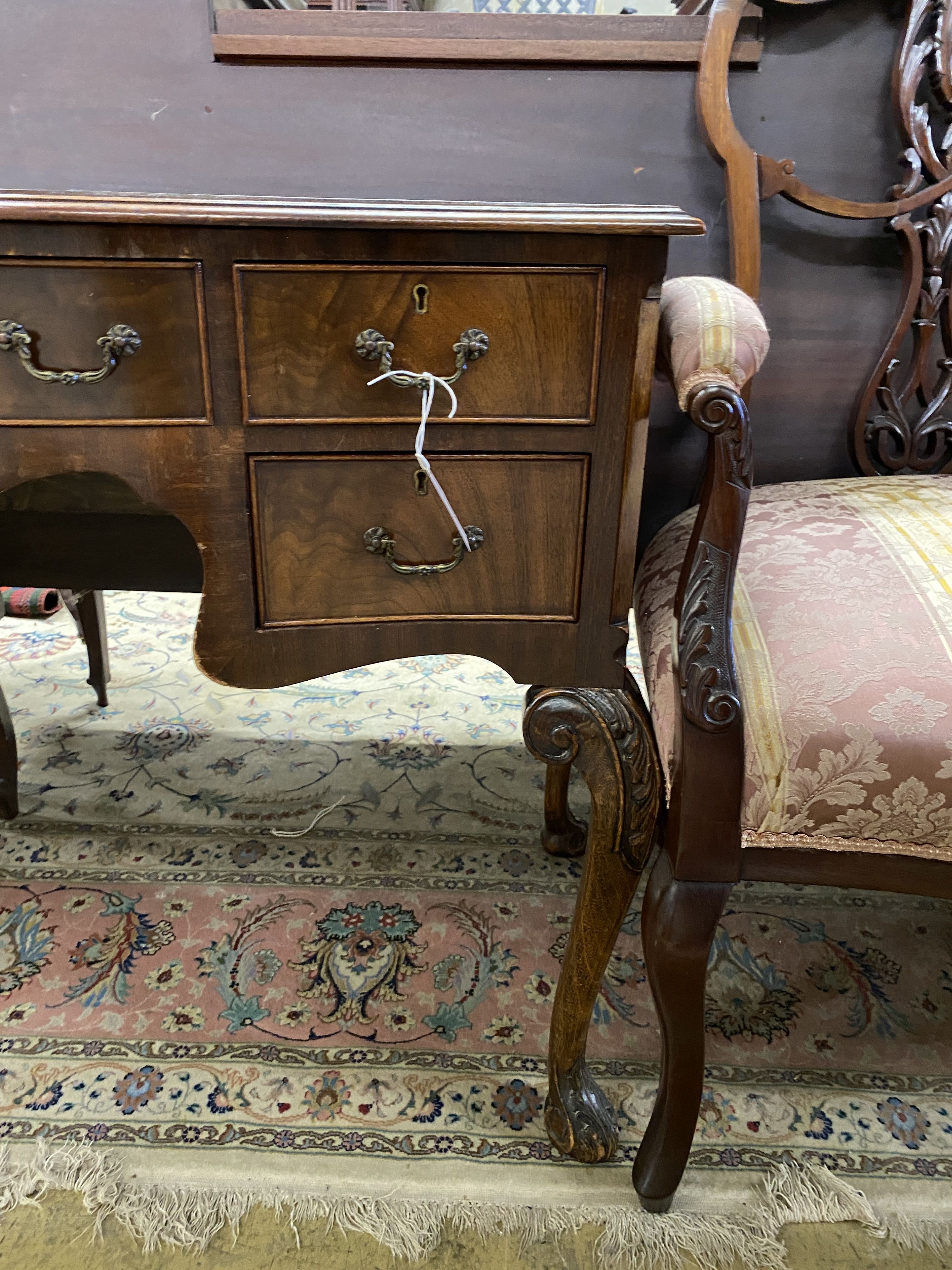 A reproduction George III style serpentine mahogany kneehole writing table, width 107cm, depth 55cm, height 78cm